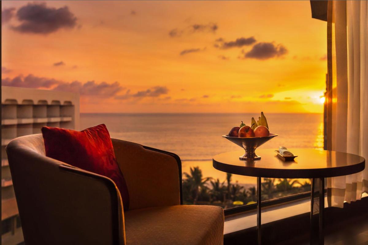 a room with a window with a view of the ocean at JW Marriott Mumbai Juhu in Mumbai