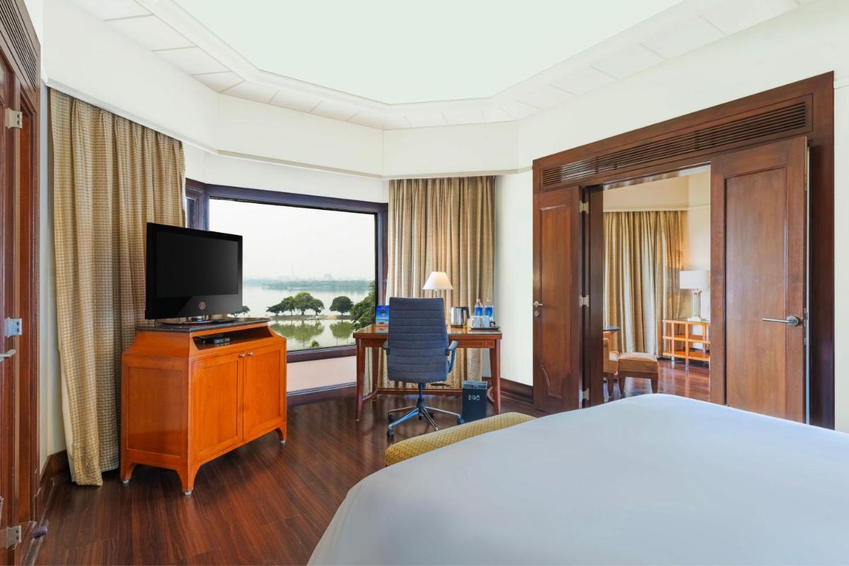 a hotel room with a bed and a flat screen tv at Hyderabad Marriott Hotel & Convention Centre in Hyderabad