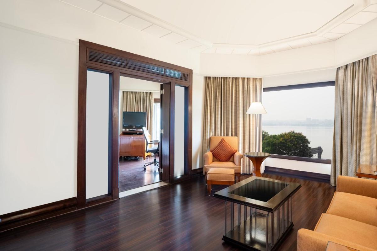 a living room with a couch and a table at Hyderabad Marriott Hotel & Convention Centre in Hyderabad