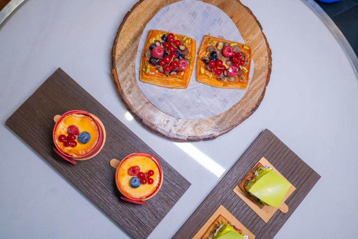 a table with a plate of food with fruit on it at Hyderabad Marriott Hotel & Convention Centre in Hyderabad