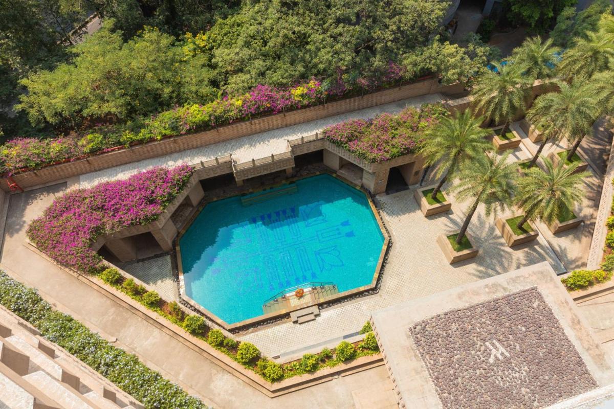 an overhead view of a swimming pool with purple flowers at Hyderabad Marriott Hotel & Convention Centre in Hyderabad