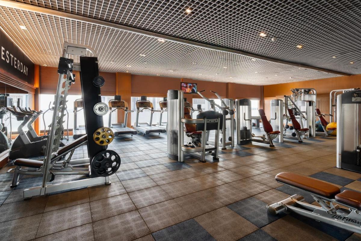 a gym with cardio equipment in a hotel room at Hyderabad Marriott Hotel & Convention Centre in Hyderabad