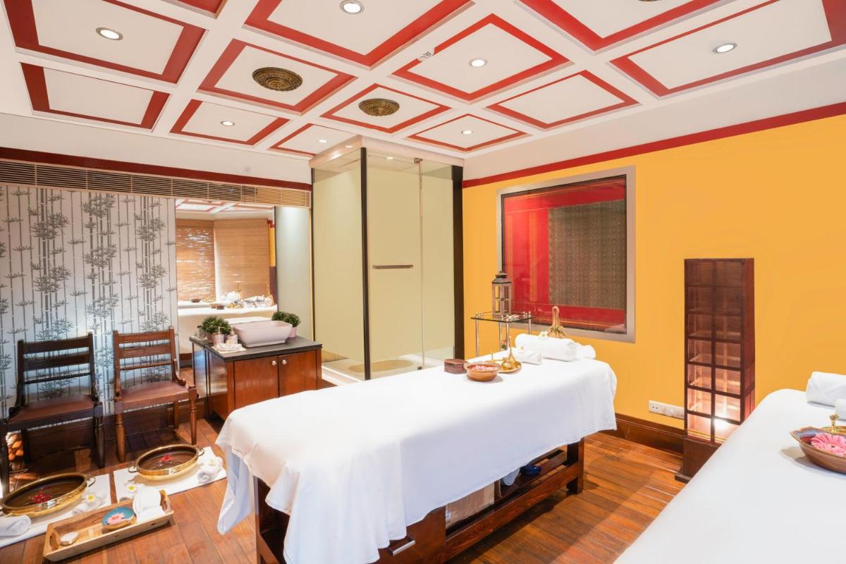 a large room with two beds and a bathroom at Hyderabad Marriott Hotel & Convention Centre in Hyderabad