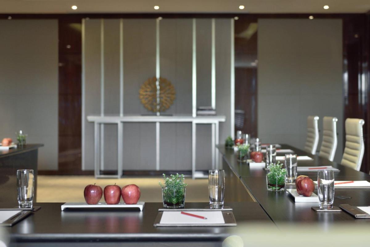 a conference room with a long table and chairs at Kochi Marriott Hotel in Cochin