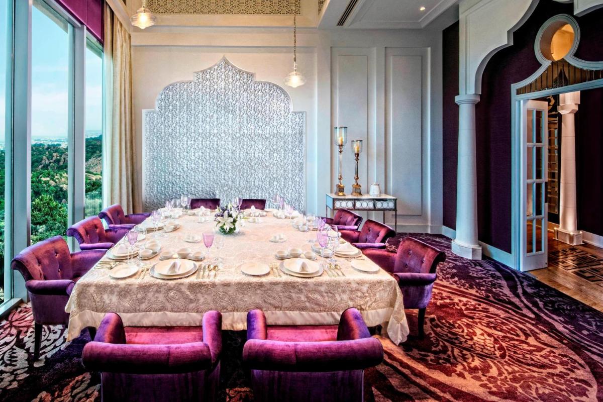 a dining room with a table and purple chairs at ITC Kohenur, a Luxury Collection Hotel, Hyderabad in Hyderabad