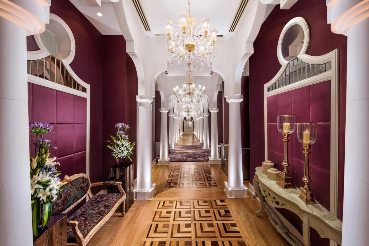 a hallway with purple walls and a chandelier at ITC Kohenur, a Luxury Collection Hotel, Hyderabad in Hyderabad