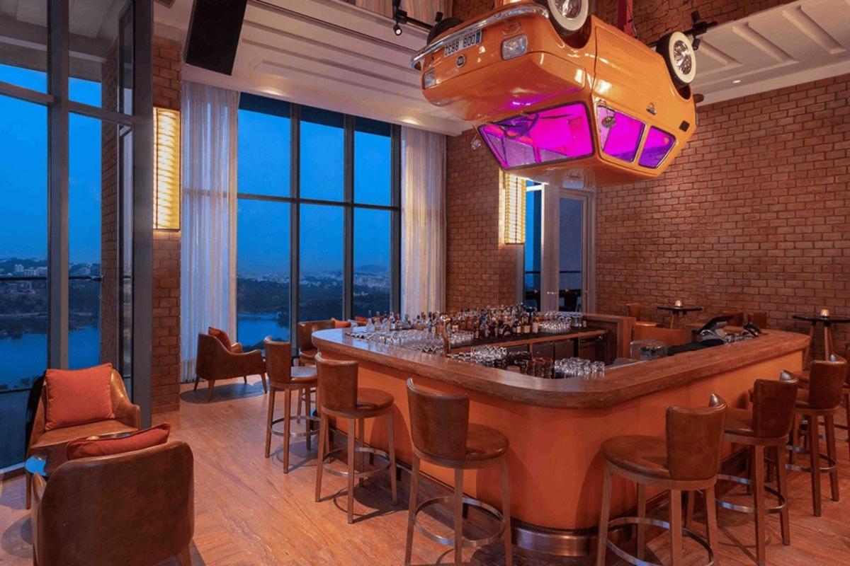 a bar in a restaurant with a view at ITC Kohenur, a Luxury Collection Hotel, Hyderabad in Hyderabad