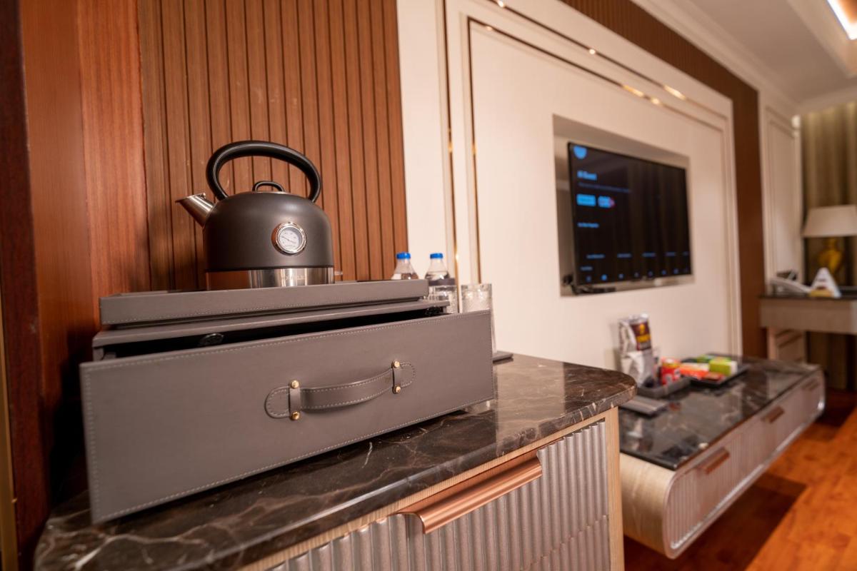 a tea kettle sitting on top of a kitchen counter at The Accord Metropolitan in Chennai