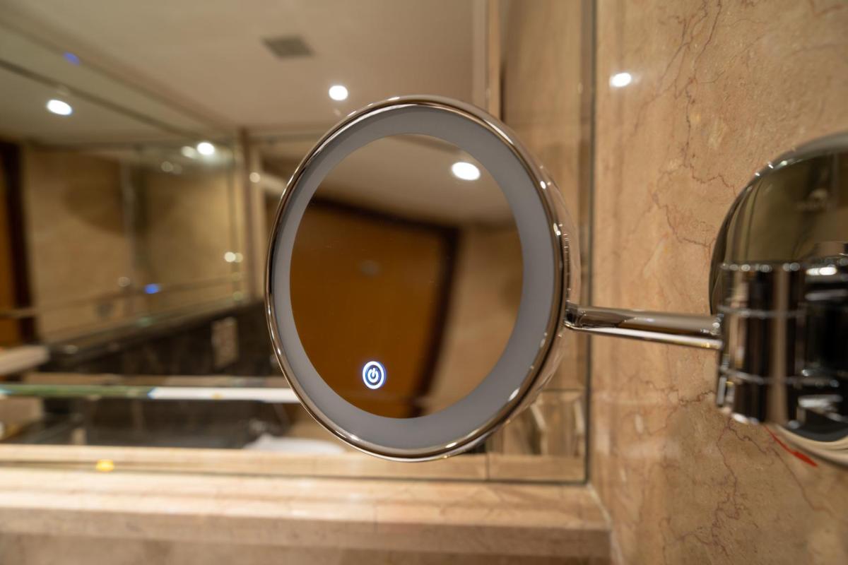 a mirror sitting on a counter in a bathroom at The Accord Metropolitan in Chennai