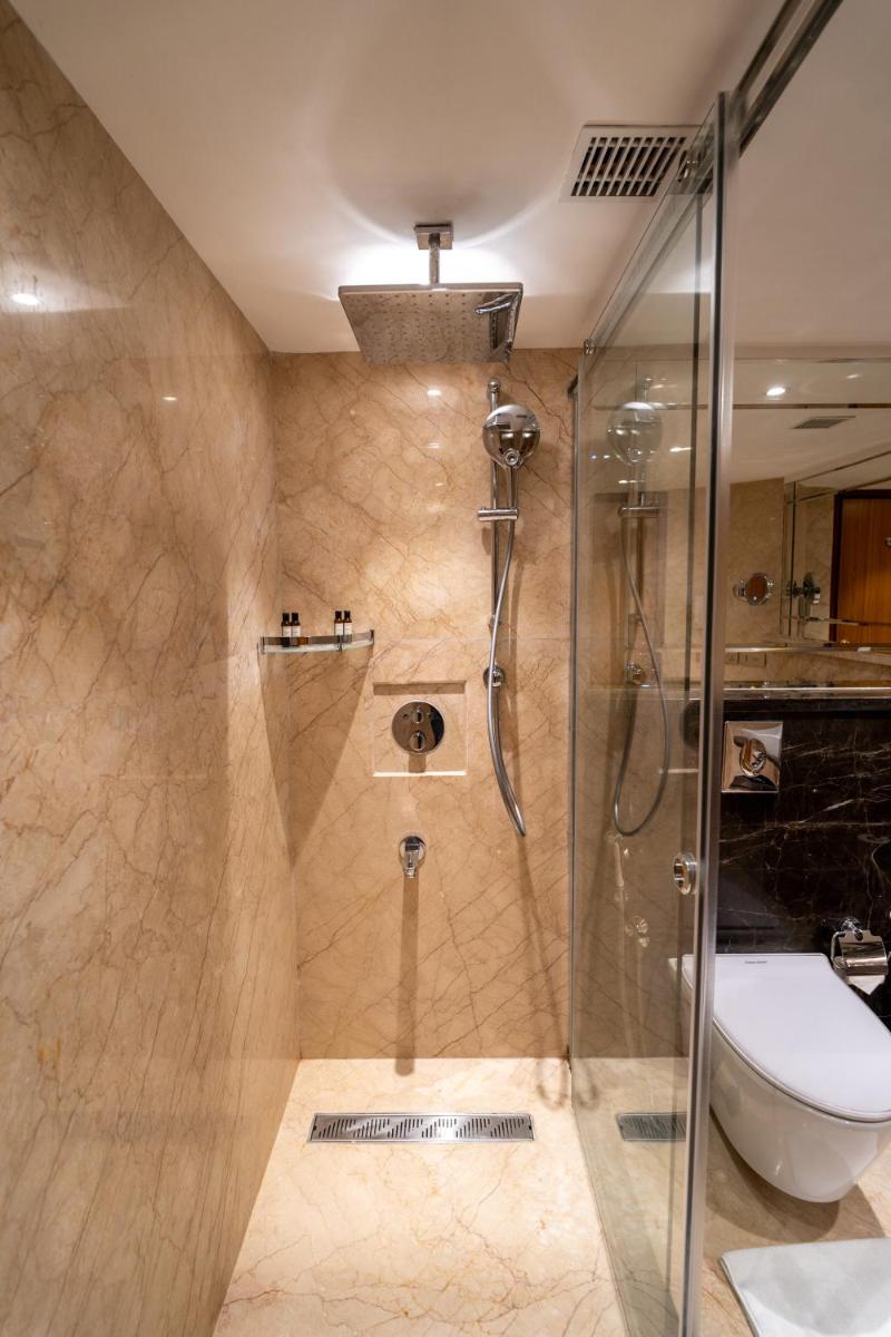 a bathroom with a shower and a toilet at The Accord Metropolitan in Chennai