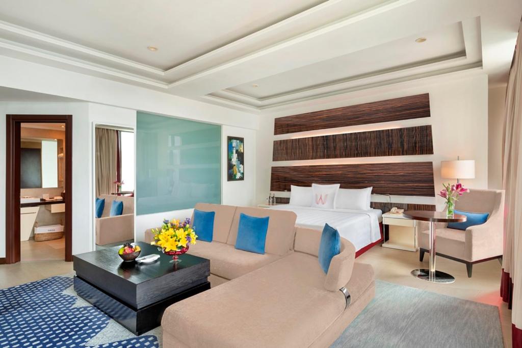 a hotel room with a bed and a couch at Welcomhotel by ITC Hotels, Dwarka, New Delhi in New Delhi a hotel room with a bed and a couch at Welcomhotel by ITC Hotels, Dwarka, New Delhi in New Delhi