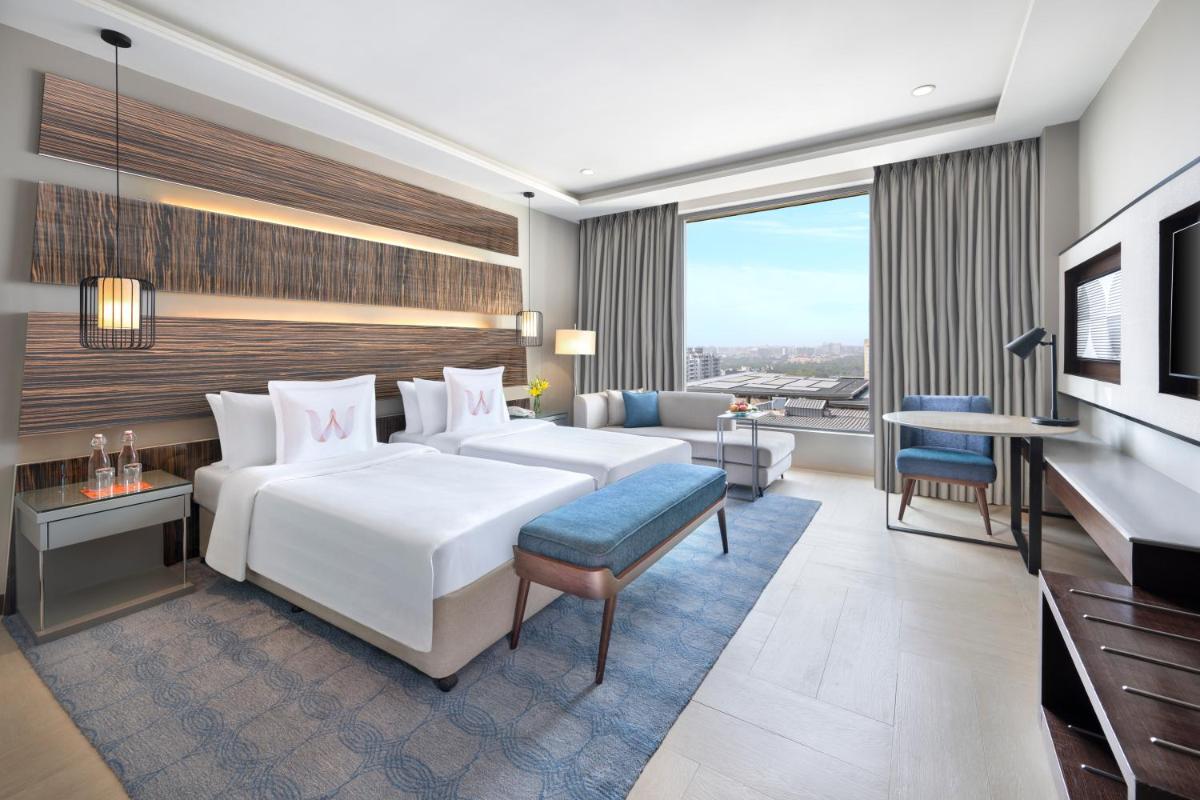 a hotel room with a bed and a couch at Welcomhotel by ITC Hotels, Dwarka, New Delhi in New Delhi a hotel room with a bed and a couch at Welcomhotel by ITC Hotels, Dwarka, New Delhi in New Delhi