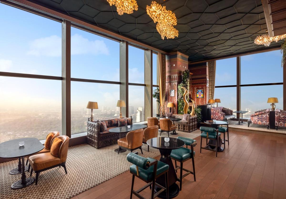 a lobby with large windows and a view of the city at The St. Regis Mumbai in Mumbai