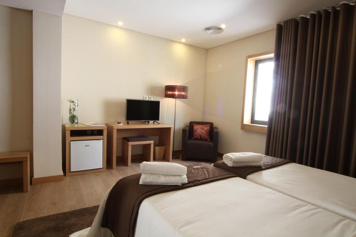 Uma cama ou camas num quarto em Douro Cister Hotel Resort