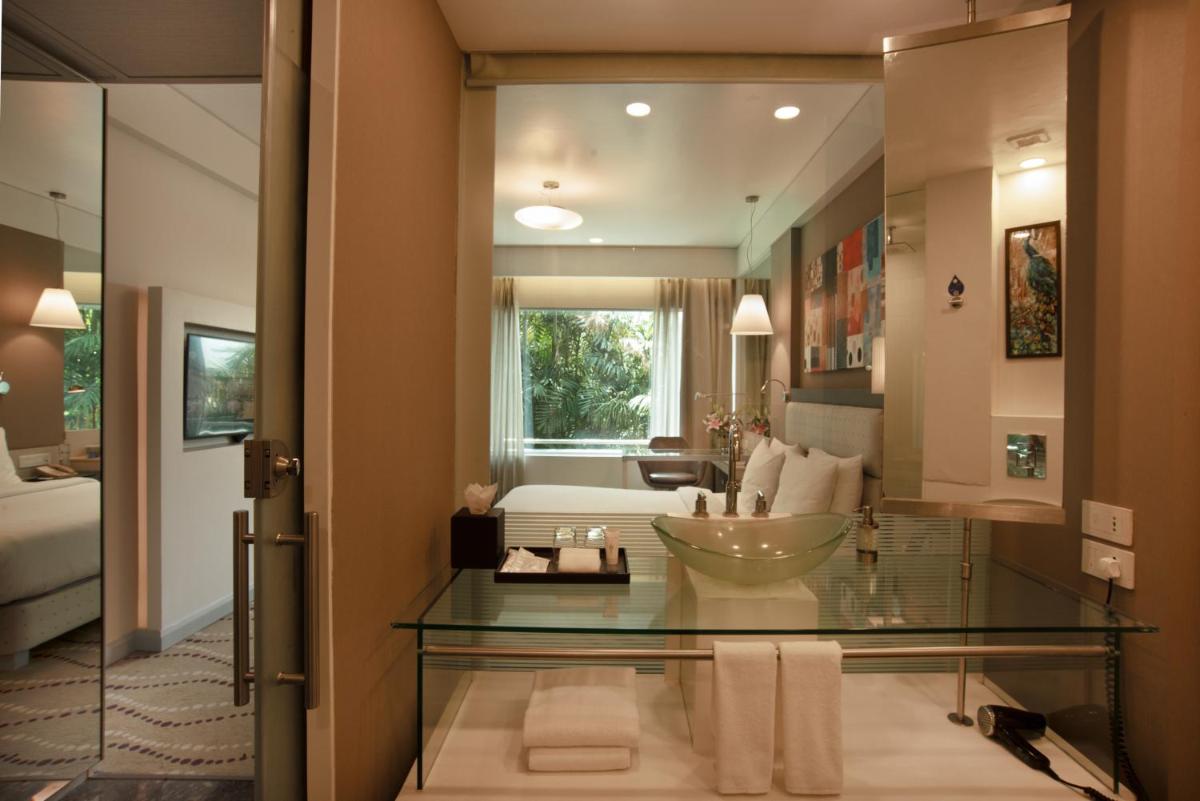 a bathroom with a glass table and a living room at Radisson Blu Bengaluru Outer Ring Road in Bengaluru
