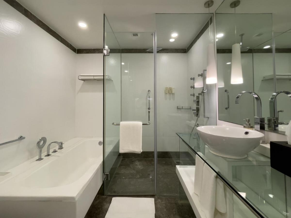 a bathroom with a glass shower and a sink at Radisson Blu Bengaluru Outer Ring Road in Bengaluru