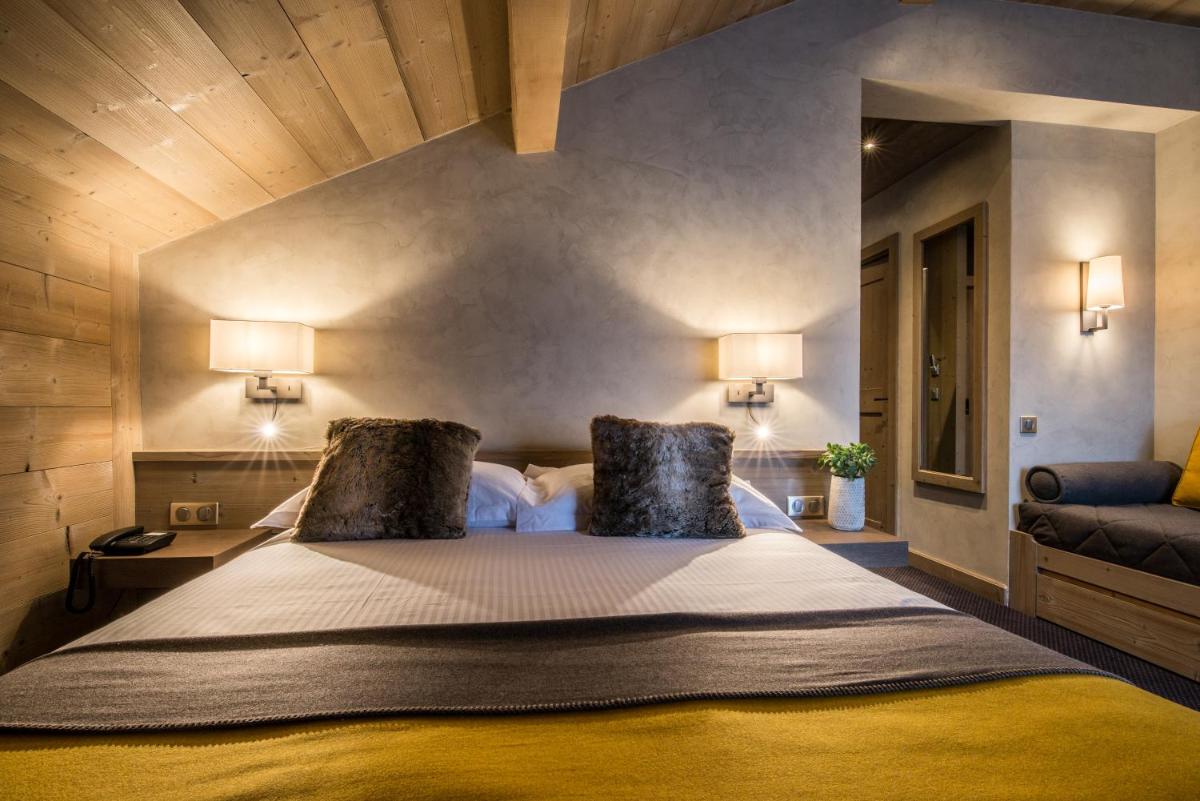 Un ou plusieurs lits dans un hébergement de l'établissement Hotel Le Samoyede