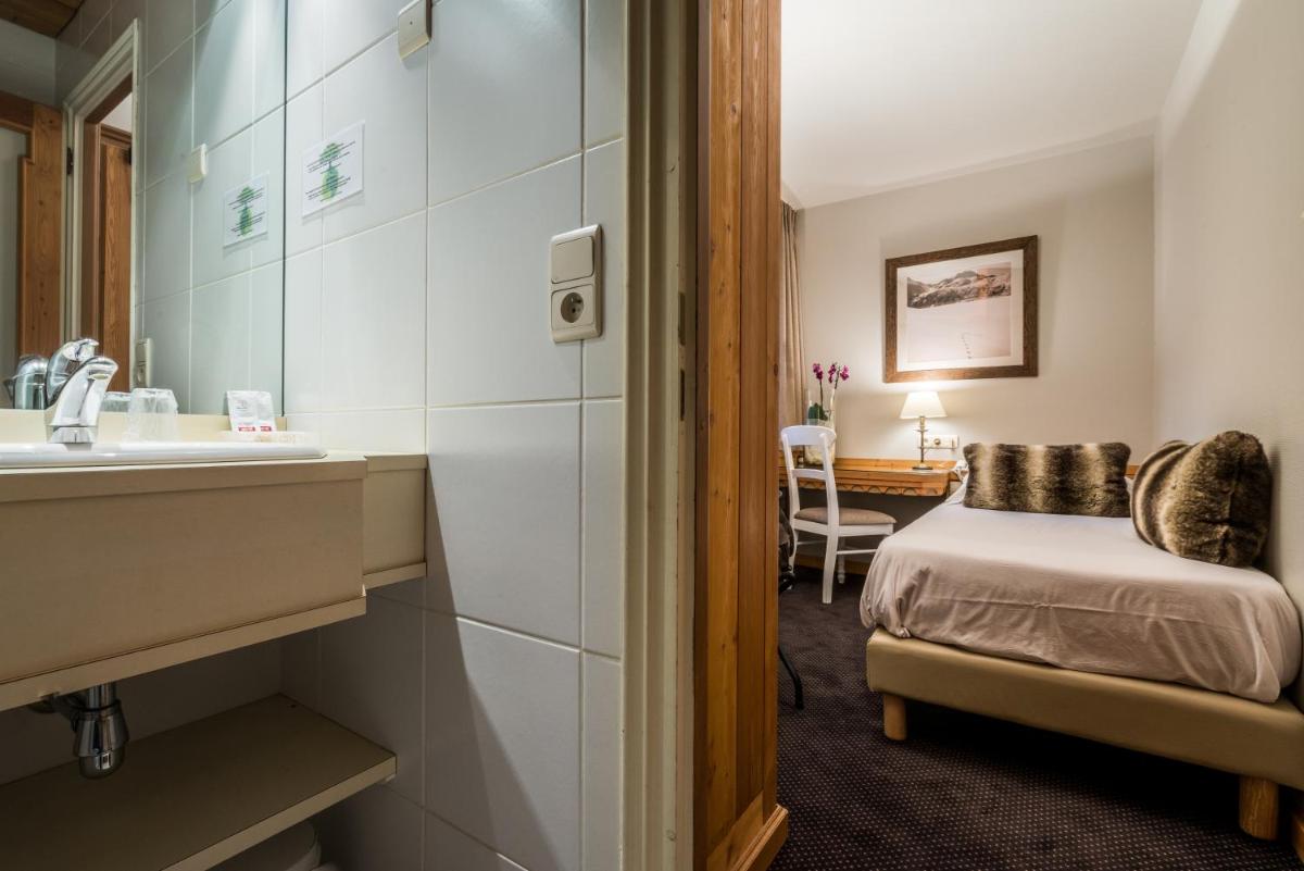 Un ou plusieurs lits dans un hébergement de l'établissement Hotel Le Samoyede