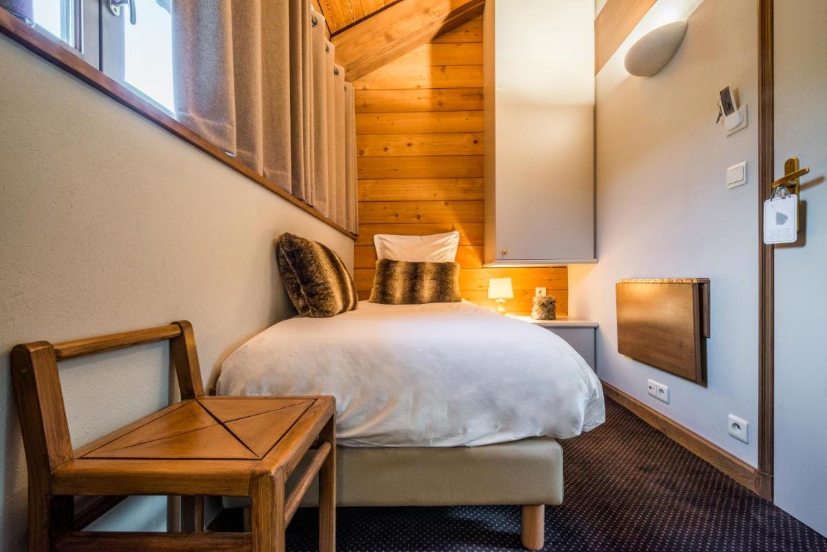 Un ou plusieurs lits dans un hébergement de l'établissement Hotel Le Samoyede