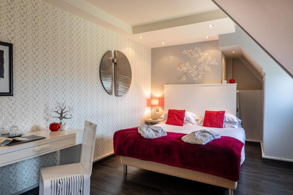 Un ou plusieurs lits dans un hébergement de l'établissement Le Bailliage Hôtel & Spa