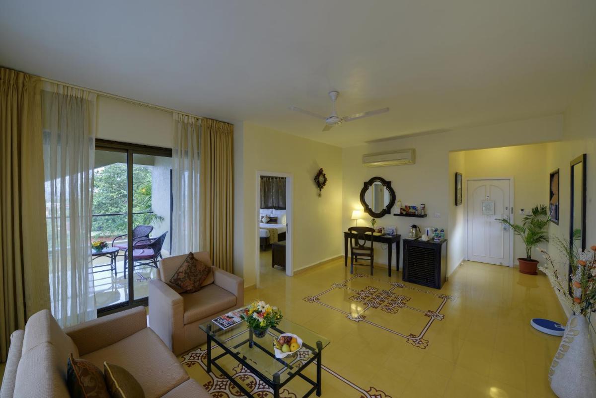 a living room with a couch and a table at The Crown Goa in Panaji