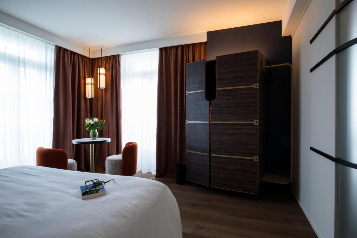 Un ou plusieurs lits dans un hébergement de l'établissement Hôtel & Spa Oceania Le Conti