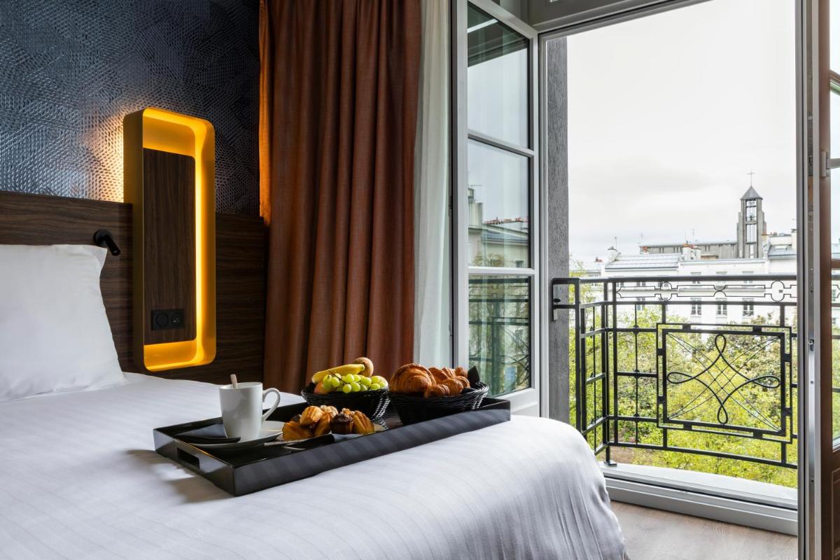 Un ou plusieurs lits dans un hébergement de l'établissement Hôtel & Spa Oceania Le Conti