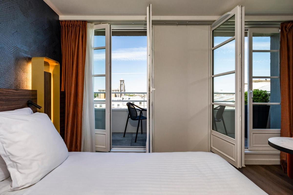 Un ou plusieurs lits dans un hébergement de l'établissement Hôtel & Spa Oceania Le Conti