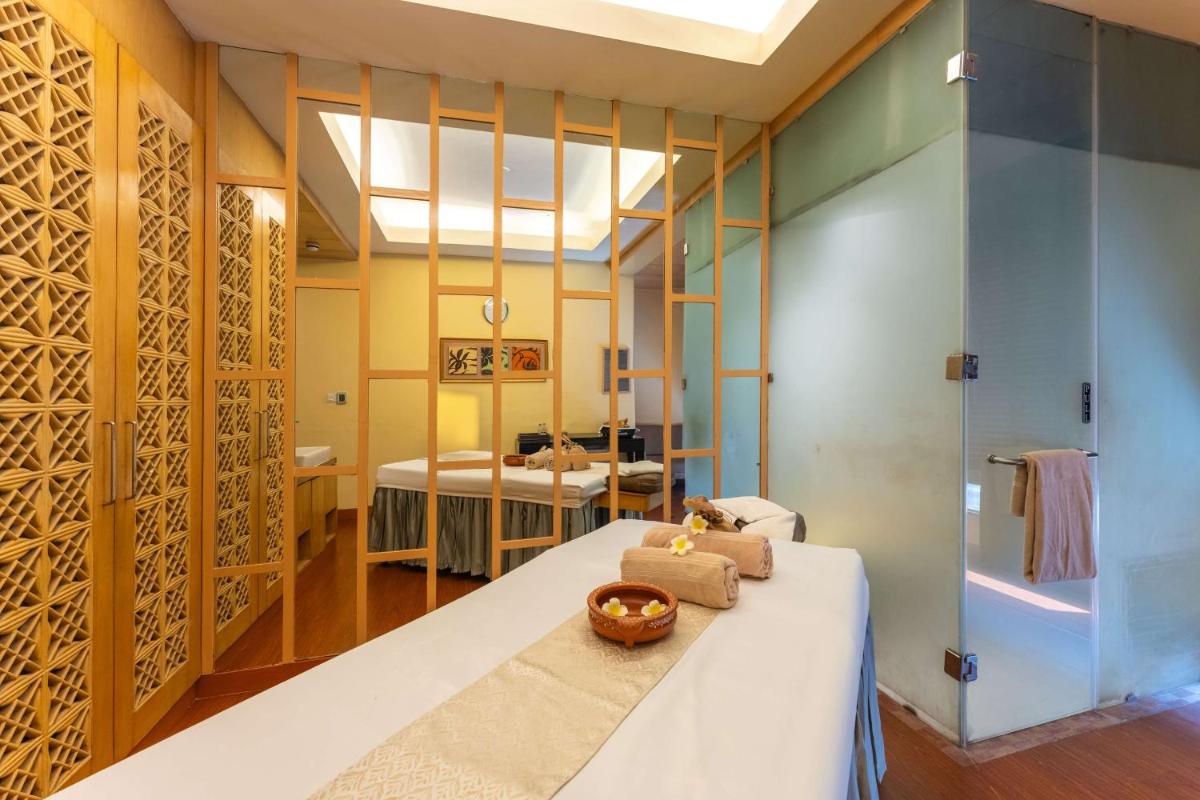 a bedroom with a bed and a bathroom at Radisson Blu Hotel, Indore in Indore