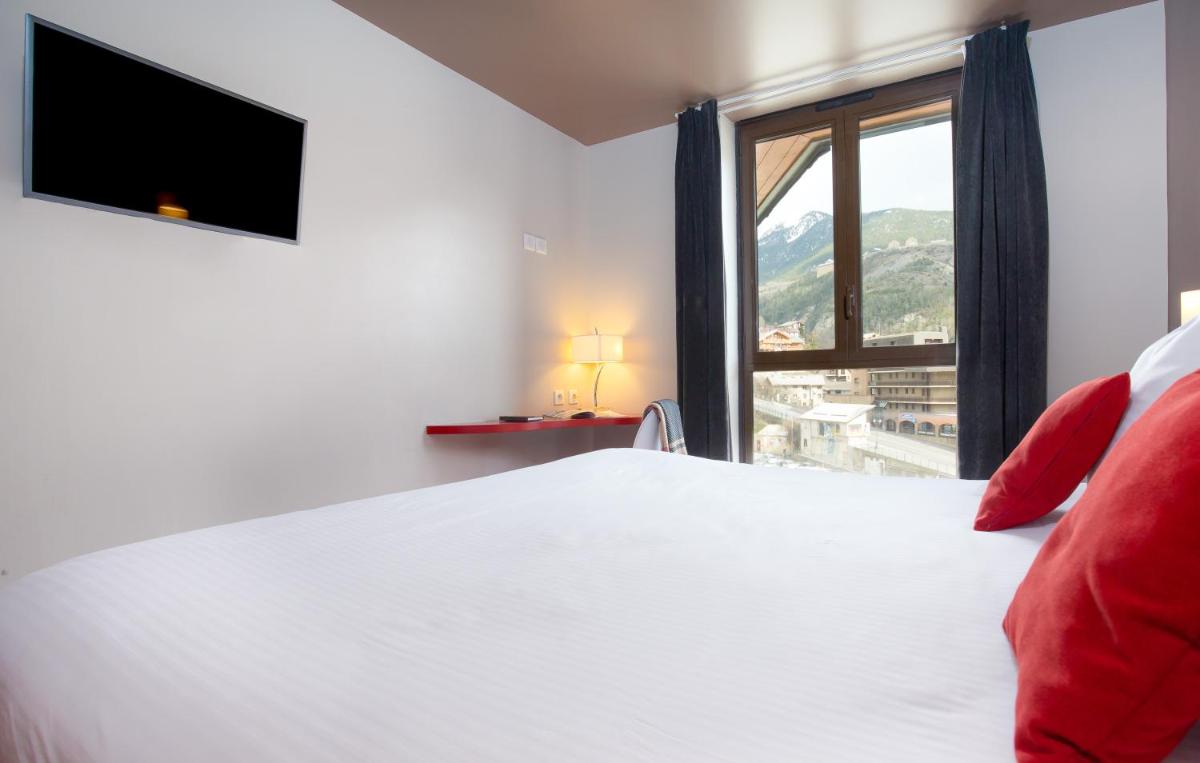 Un ou plusieurs lits dans un hébergement de l'établissement SOWELL HOTELS Le Parc & Spa