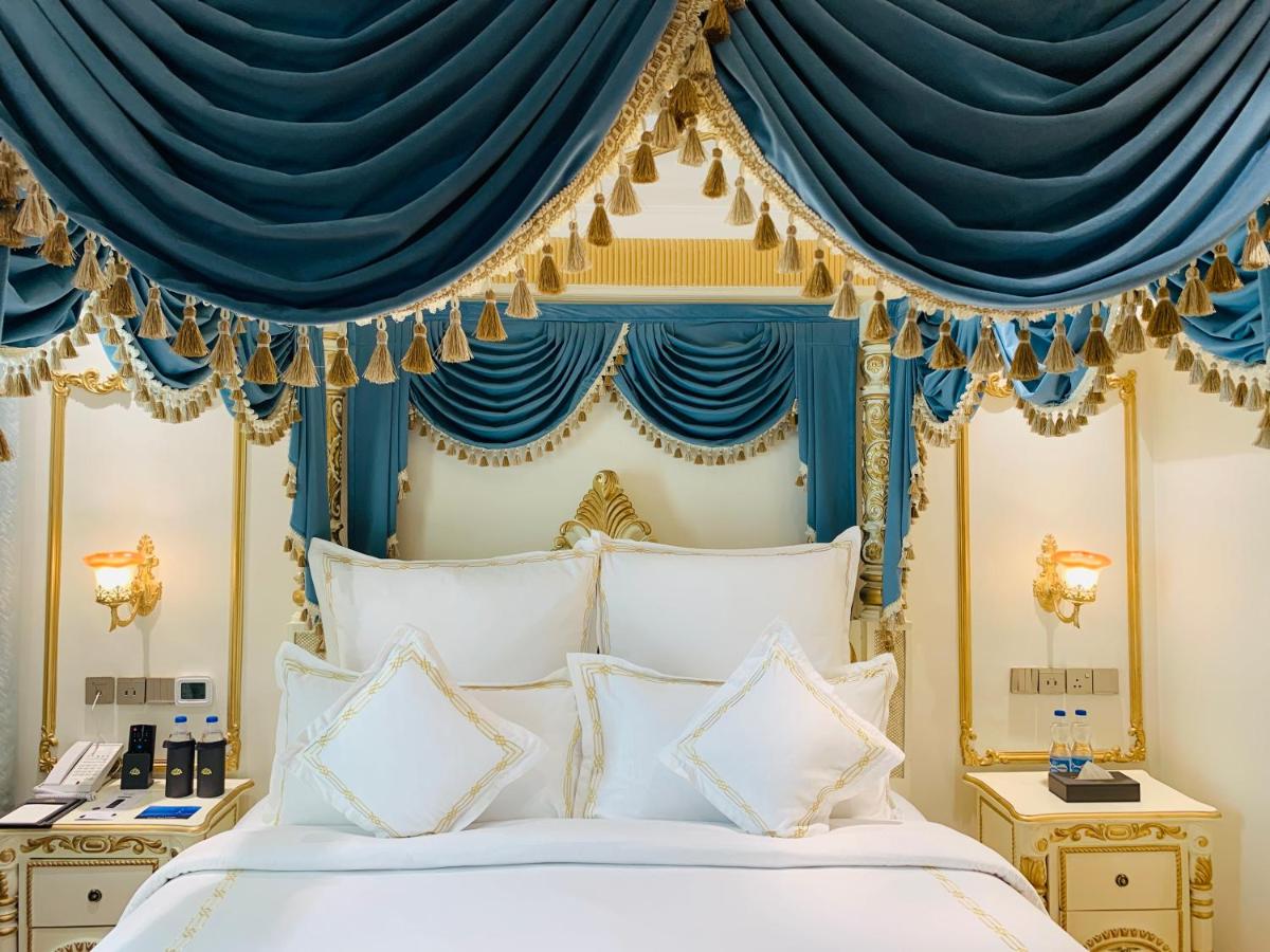 a bed with a blue and gold canopy at The Accord Metropolitan in Chennai