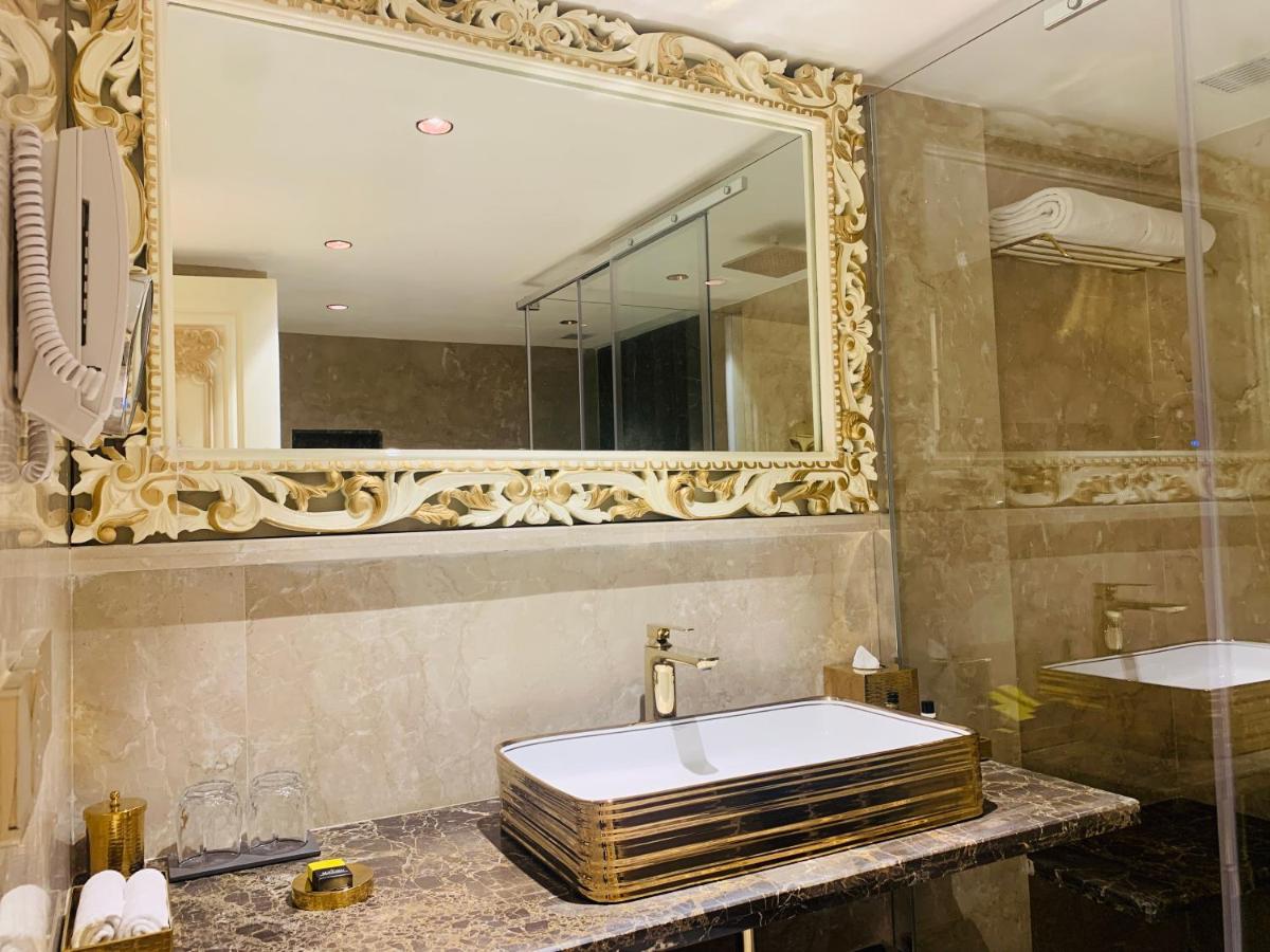 a bathroom with a large mirror and a sink at The Accord Metropolitan in Chennai