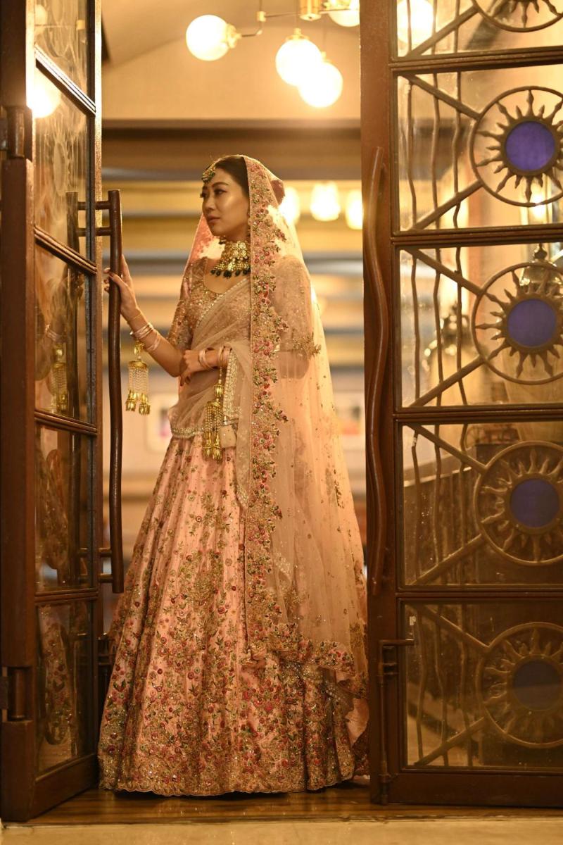 a woman in a dress standing in front of a door at Radisson Blu Hotel Pune Kharadi in Pune