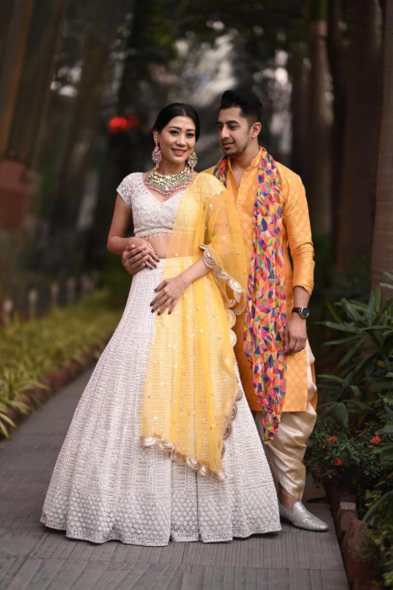 a man and a woman in a yellow dress at Radisson Blu Hotel Pune Kharadi in Pune