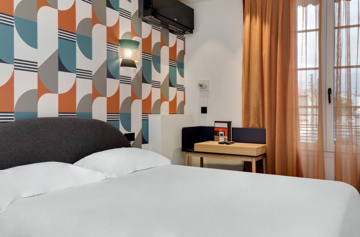 Un ou plusieurs lits dans un hébergement de l'établissement Hôtel De L'octroi