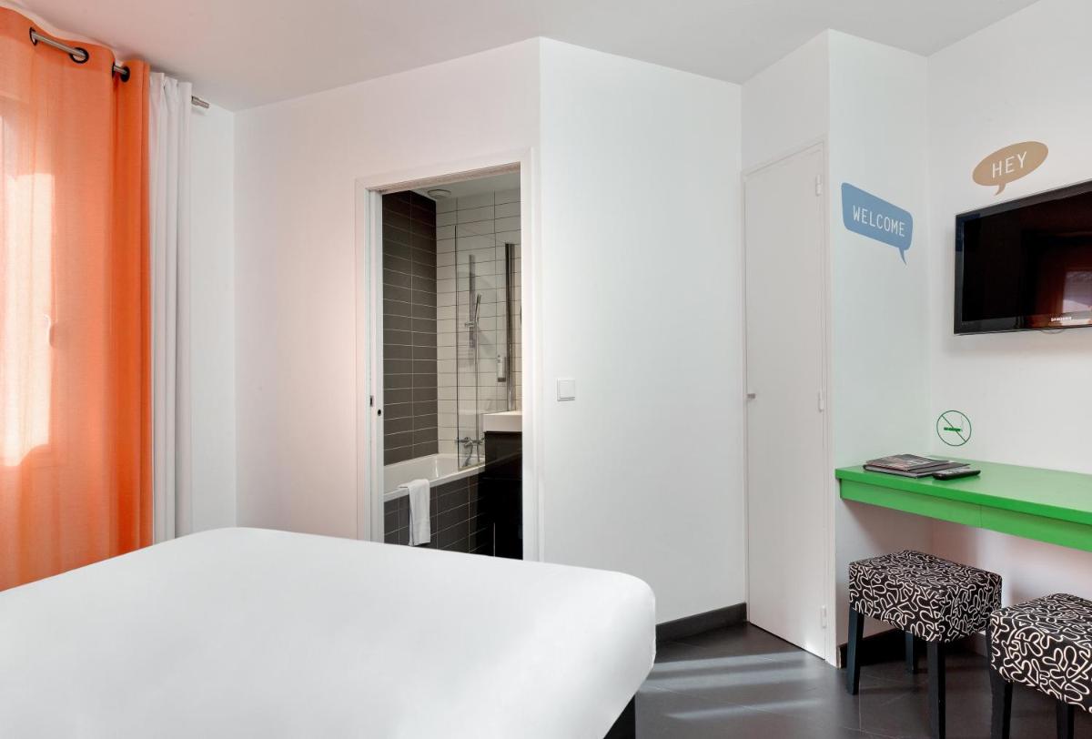 Un ou plusieurs lits dans un hébergement de l'établissement Hôtel De L'octroi