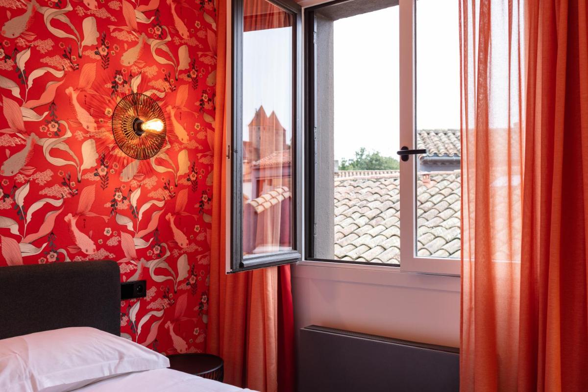 Un ou plusieurs lits dans un hébergement de l'établissement Hôtel De L'octroi