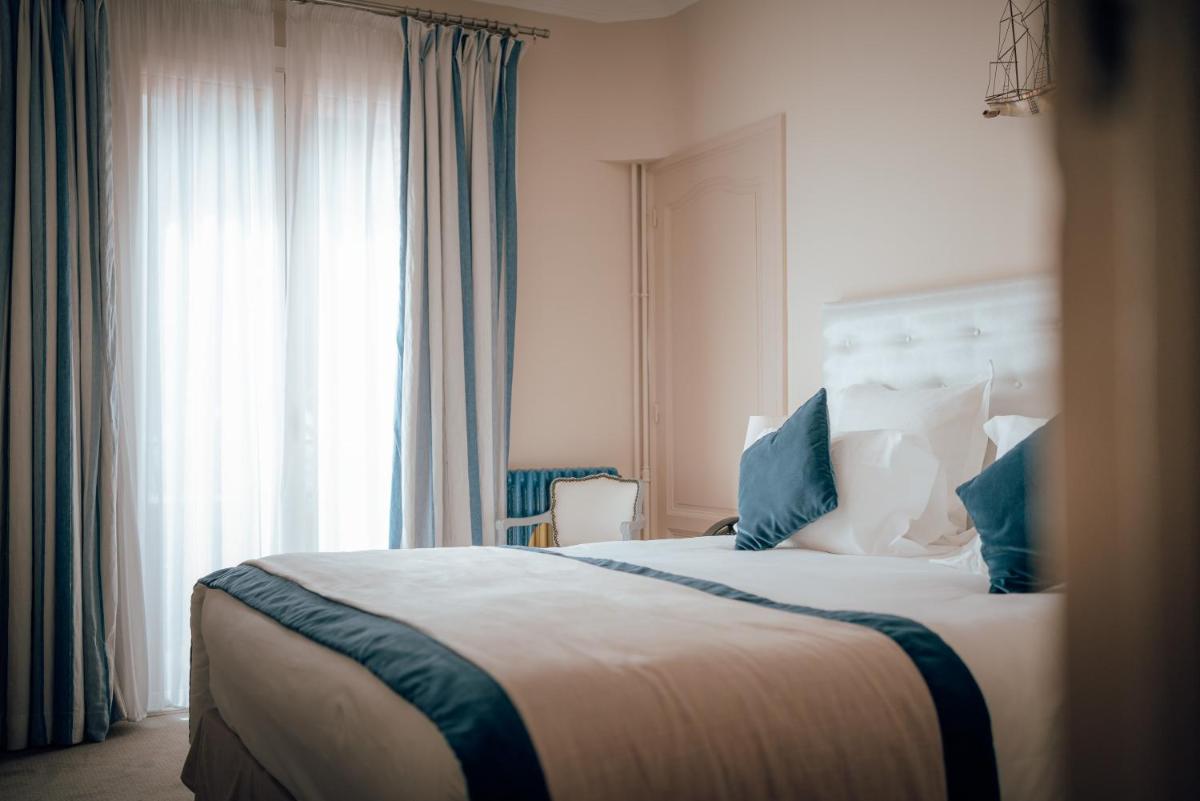 Un ou plusieurs lits dans un hébergement de l'établissement Ermitage de l'Oasis & Spa - Cannes Mandelieu