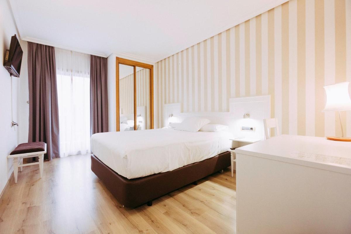 Cama o camas de una habitación en Hotel Alfonso I