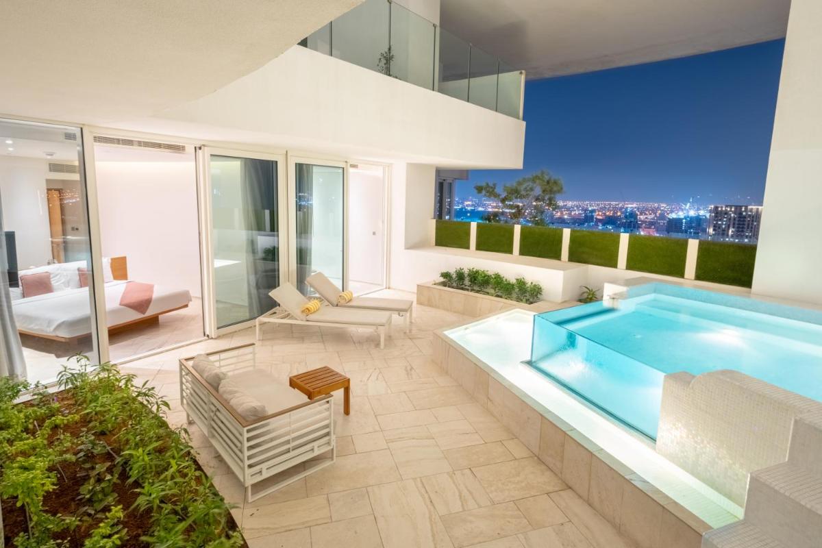 a pool in a house with a view at FIVE Jumeirah Village in Dubai a pool in a house with a view at FIVE Jumeirah Village in Dubai