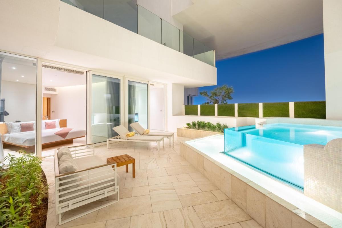 a villa with a swimming pool and a living room at FIVE Jumeirah Village in Dubai