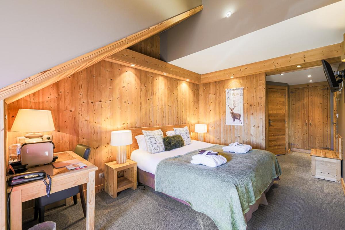 Un ou plusieurs lits dans un hébergement de l'établissement Hôtel et Spa les Clarines