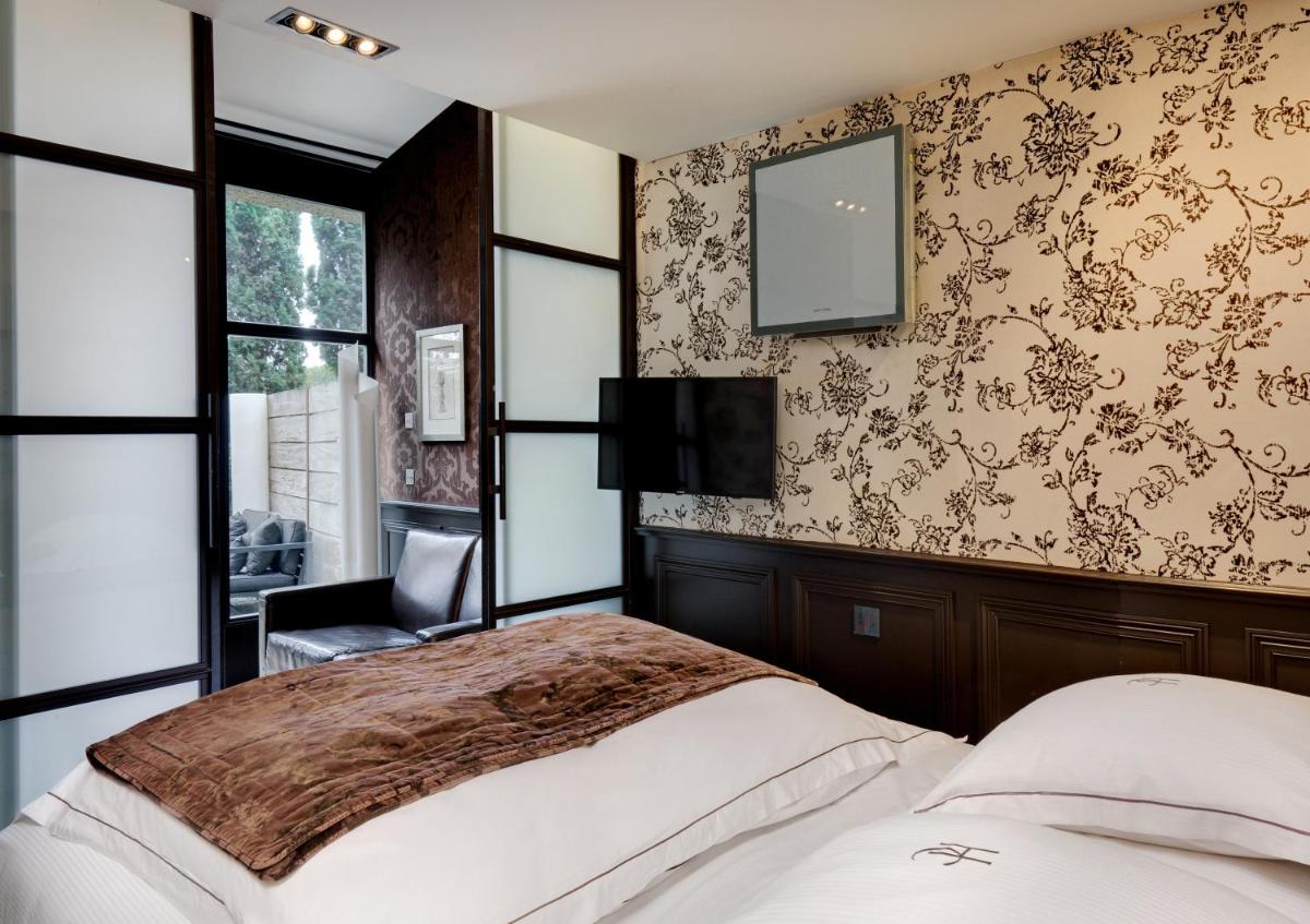 Un ou plusieurs lits dans un hébergement de l'établissement Hôtel du Château & Spa - Teritoria