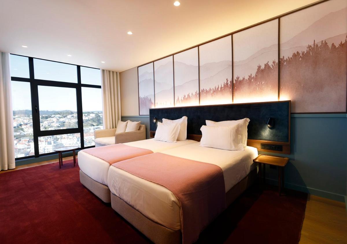 Uma cama ou camas num quarto em Montebelo Viseu Congress Hotel & Spa