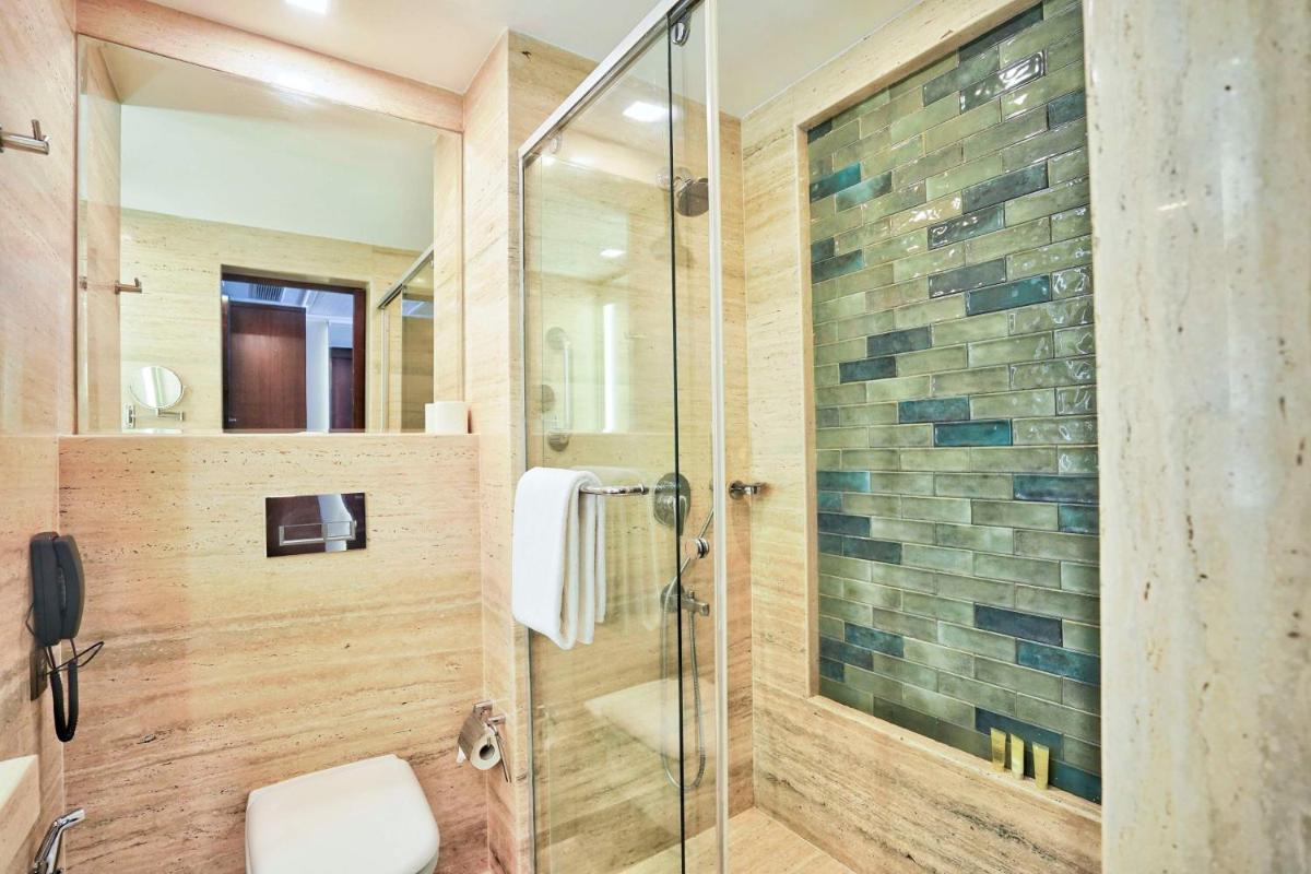 a bathroom with a shower with a glass door at Hyatt Centric Rajpur Road Dehradun in Dehradun