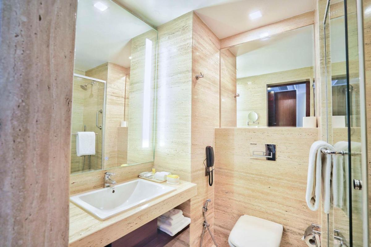 a bathroom with a sink and a phone at Hyatt Centric Rajpur Road Dehradun in Dehradun