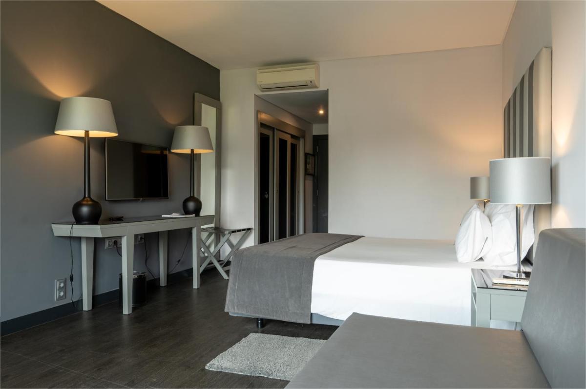 Uma cama ou camas num quarto em Vila Gale Evora