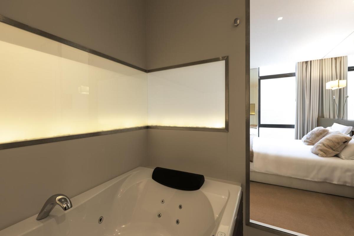 Uma cama ou camas num quarto em Tempus Hotel & Spa