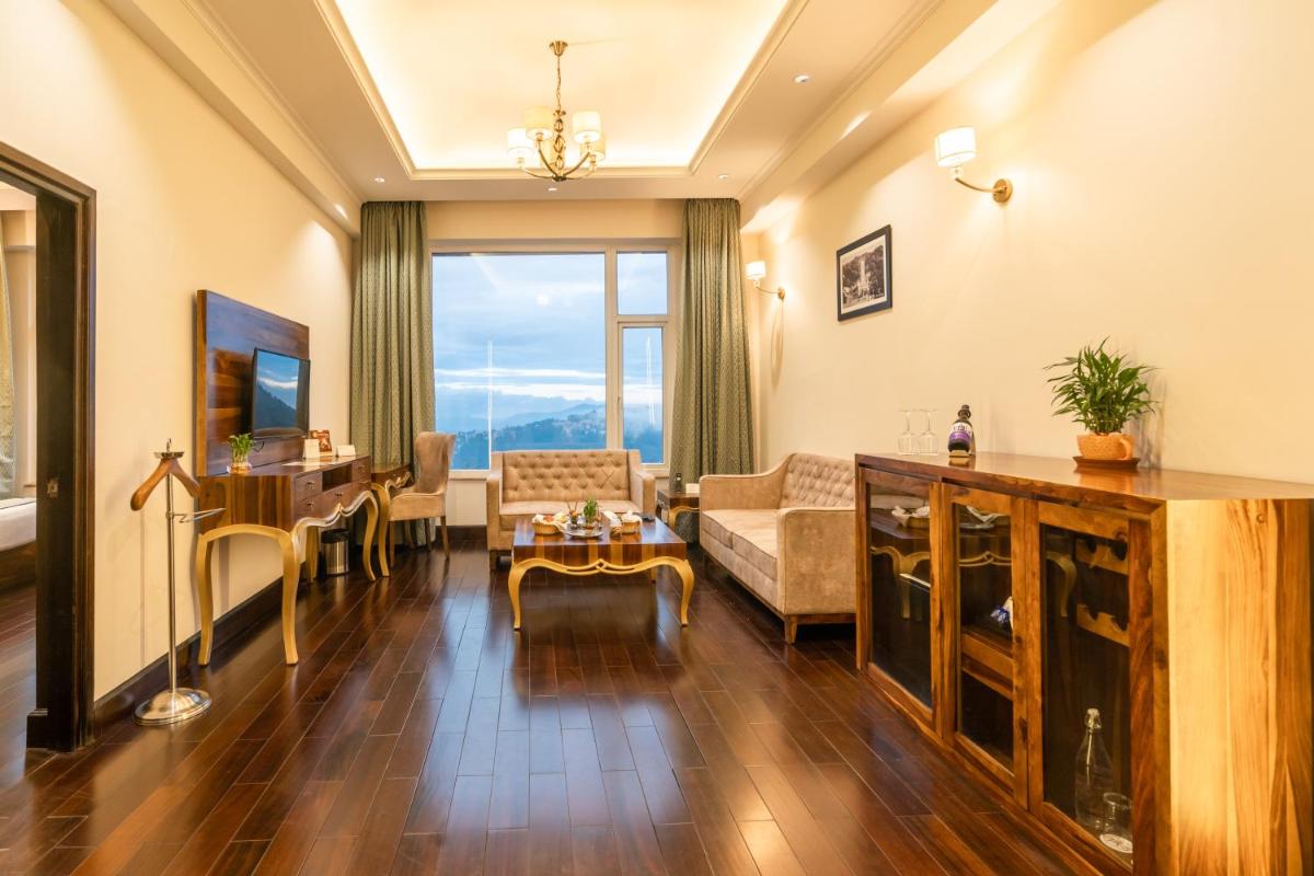 a living room with a couch and a table at The Orchid Shimla in Shimla