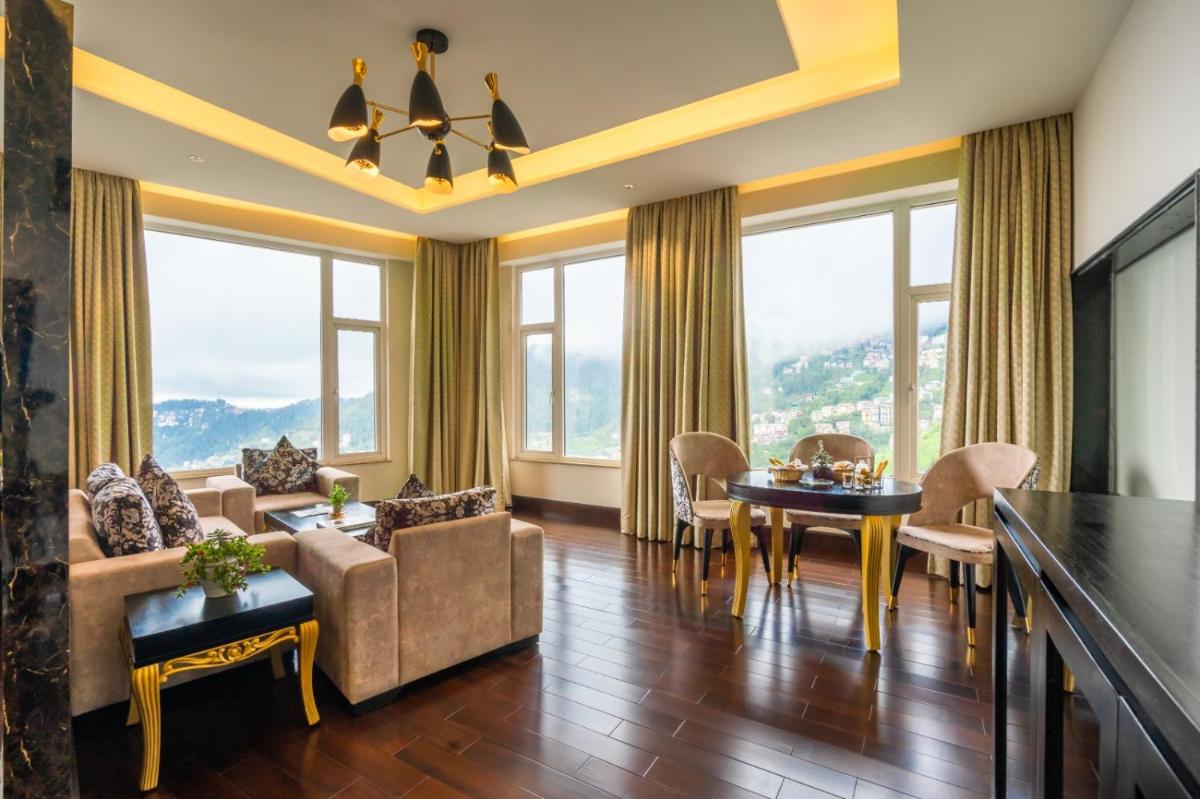 a living room with a couch and a table at The Orchid Shimla in Shimla